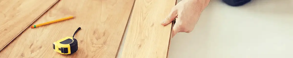 A professional installing wood flooring in Pueblo, CO