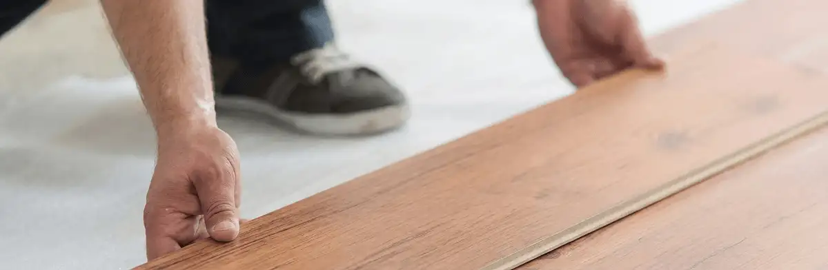 A professional installing laminate flooring in Pueblo, CO