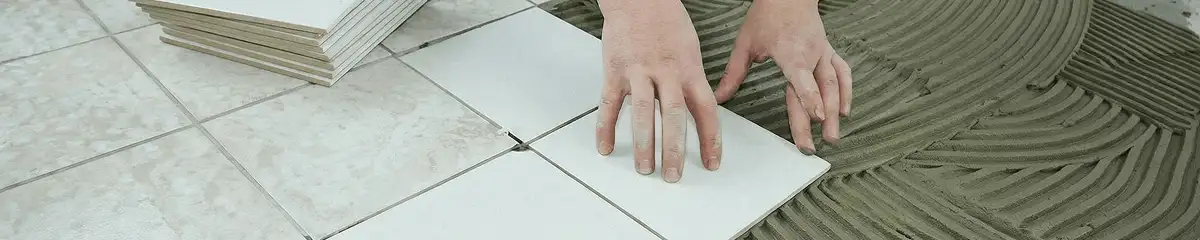 Professional installing white tile floors in Pueblo, CO